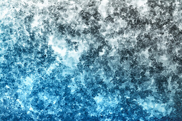 Close-up snow texture on the window with a beautiful gradient in blue and light blue tones.