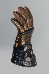 Medieval knightly brown plate gauntlet from Italian armor, in the form of a lion's face and mane,...