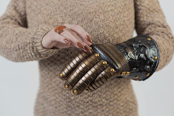Medieval knightly brown plate gauntlet from Italian armor, in the form of a lion's face and mane,...