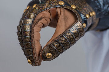 Medieval knightly brown plate gauntlet from Italian armor, in the form of a lion's face and mane,...