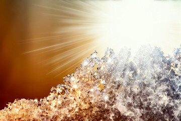 Natural snow texture with a gradient in the rays of the sun at sunset with beautiful rays. Close-up snow texture with creative gradient at sunset.