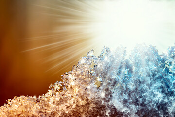 Natural snow texture with a gradient in the rays of the sun at sunset with beautiful rays. Close-up snow texture with creative gradient at sunset.