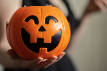 trick or treat,Happy Halloween,pumpkin candy bowl with lollipops keeps a woman for children in front of the house