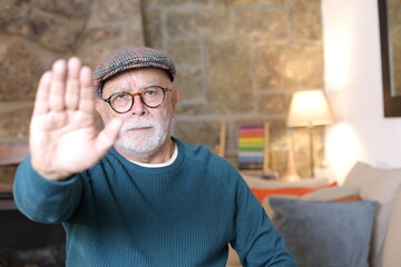 Senior man showing refusal with hand gesture 