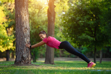 Athletic young woman in sports dress doing fitness exercise