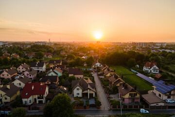 Aerial view of residential houses in suburban rural area at sunset.