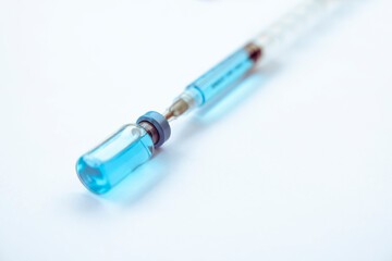 Fototapeta premium Close-up vials with vaccine and syringe for virus protection isolated on white background. Horizontal composition.