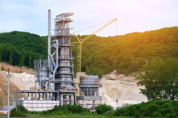 Cement plant with high metal factory structure at industrial production area. Manufacture and...