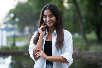 Portrait of a beautiful, happy and attractive Caucasian or Arabian brunette girl dressed in casual style.