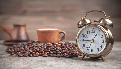 Clay coffee cup and alarm clock. Coffee time