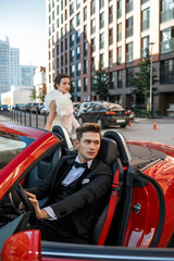 couple in the red car in the city