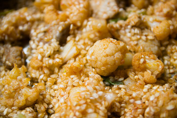 Detail of the precooking of a rice with cauliflower and pork ribs