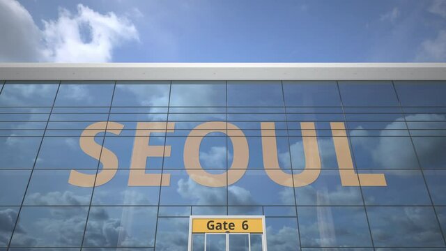 Commercial airplane reflecting in airport terminal with SEOUL text