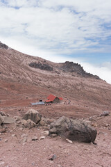 Great imposing mountain in the Andes with clouds around it.