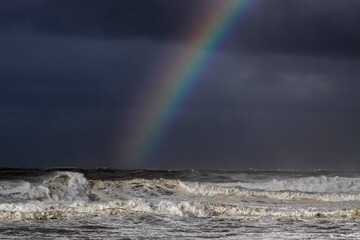 Fototapeta na wymiar Stormy seascape with rainbow