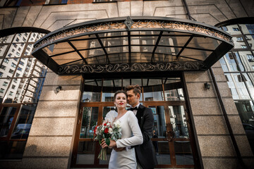 beautiful couple in front of a house