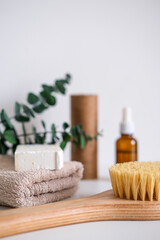 Fototapeta na wymiar Massage wooden body brush on the background of spa items. Homemade body care. Dry lymphatic drainage massage and spa treatments.
