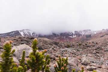 Great imposing mountain in the Andes with clouds around it.