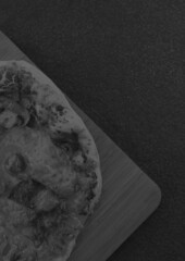 Composition of close up of fresh black and white pizza on gray background