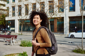 Fototapeta premium Cute young woman smiling at camera in the city