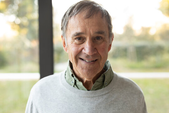 Portrait of happy caucasian senior man looking at camera