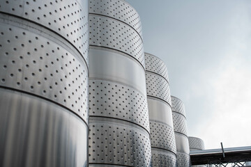 modern winery. Steel wine tanks for wine fermentation at a winery. modern wine factory with large...