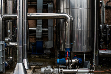 modern winery. Steel wine tanks for wine fermentation at a winery. modern wine factory with large...