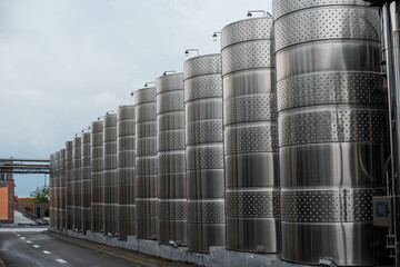 modern winery. Steel wine tanks for wine fermentation at a winery. modern wine factory with large...
