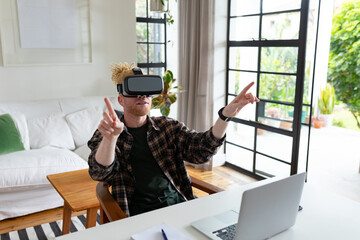 Albino african american man with dreadlocks working from home and using vr headsets