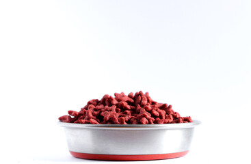 Dry red cat food in metal bowl isolated on white background