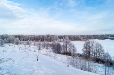 Fototapeta na wymiar The Winter landscape with hilly terrain in Russia on turn blue the background a sky.