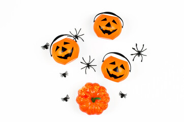 Decorations for halloween on a white background. Pumpkins and spiders and spiders on a white background, top view, flat lay. Halloween party