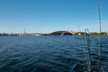 Fototapeta premium Fishing pole and reel closeup from a boat on the ocean in Stavanger Norway