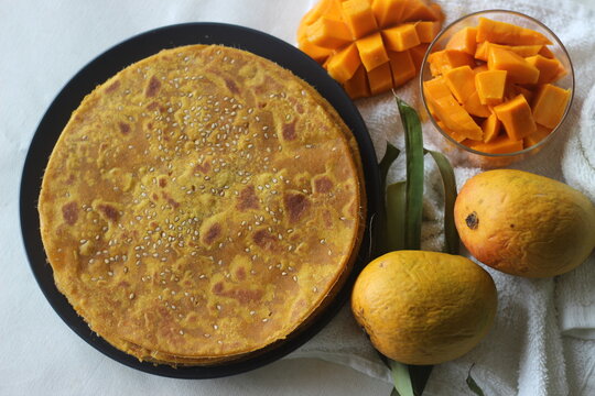 Mango Paratha. Indian flatbread made of wheat flour and mango pulp. A sweet version of Indian flatbread with fresh mangoes topped with sesame seeds