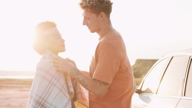 A guy in love straightens the bedspread on his frozen girlfriend in nature