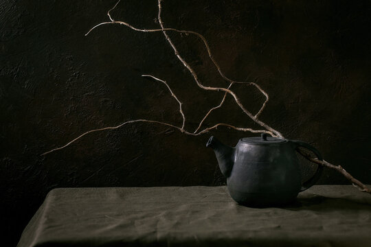 Craft handmade ceramic teapot with dark background