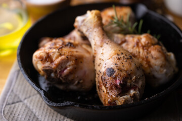 baked chicken drumsticks in iron skillet pan