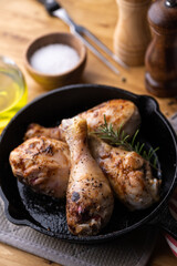 baked chicken drumsticks in iron skillet pan
