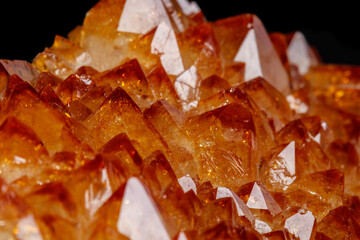 Macro mineral stone Citrine in rock in crystals on a black background