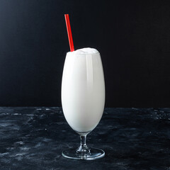 Dairy products. Flat lay. Glass of milk or kefir or yogurt on dark background