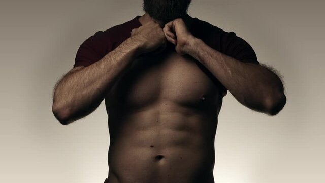 Female hands slowly touching torso with abs of male