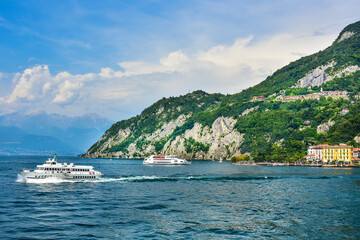 Fototapeta premium the beautiful town of Varenna, a ferry in Lake Como, Italy 