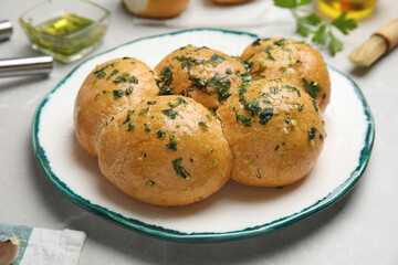 Traditional Ukrainian bread (Pampushky) with garlic on light table