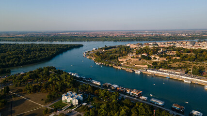 Sava meets Danube river, captured from the air during sunset. Aerial view of the estuary of the Sava river in Danube river near Kalemegdan fortress Belgrade, Serbia.