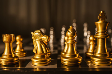 Board game chess. Figures of gold color close-up.