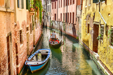 Gondola cruise on the canal in Venice, typical architecture of Italy
