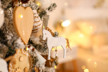 christmas decoration on the tree, wooden toys on the tree, christmas tree decoration © annakolesnicova