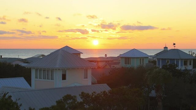 High angle view on colorful yellow sunset with sea ocean landscape of Gulf of Mexico in Seaside, Florida from wooden rooftop terrace building patio or house balcony cityscape