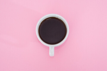 cup of black coffee on a pink background.