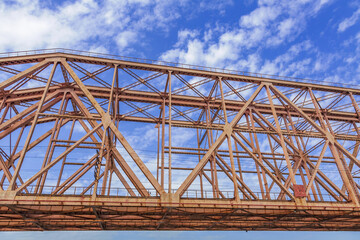 Railway transport bridge made of steel piles and beams against blue sky